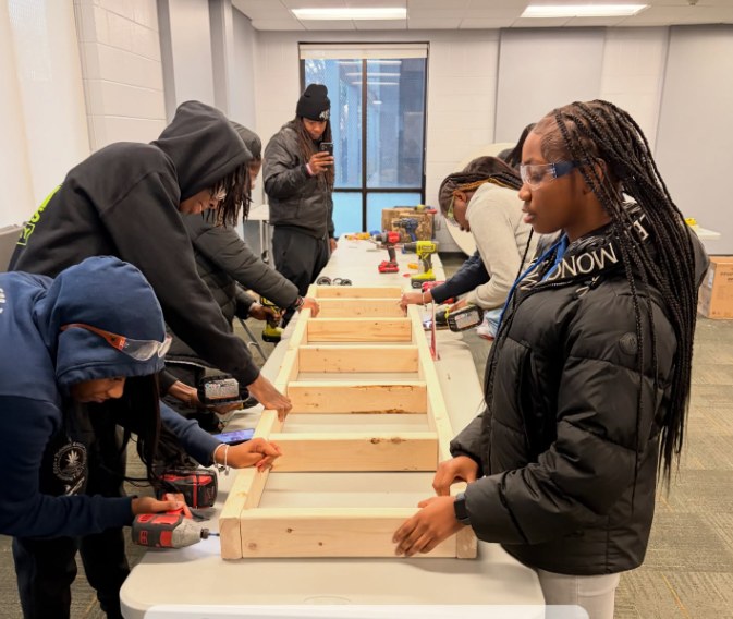 Young participants actively building a framed structure