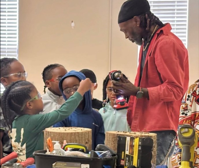 Instructor introducing tools and skilled trades to young participants