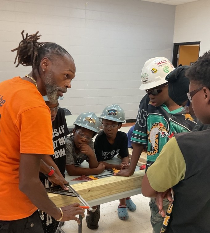 Teenz on Point youth learning safe tool use with an instructor
